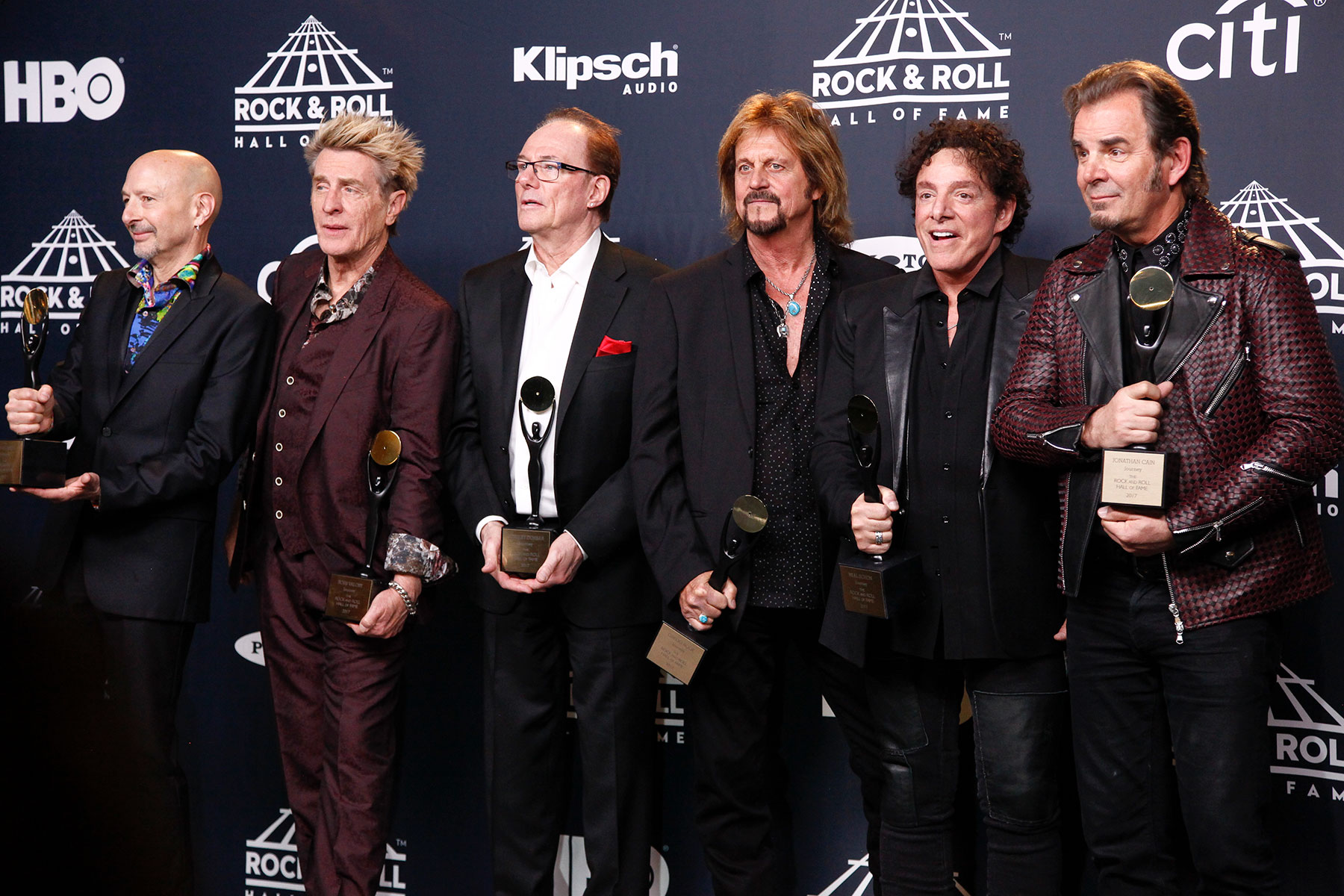 Steve Smith, from left, Ross Valory, Aynsley Dunbar, Gregg Rolie, Neal Schon and Jonathan Cain of the band Journey pose in the 2017 Rock and Roll Hall of Fame induction ceremony press room at the Barclays Center on Friday, April 7, 2017, in New York. (Photo by Andy Kropa/Invision/AP)