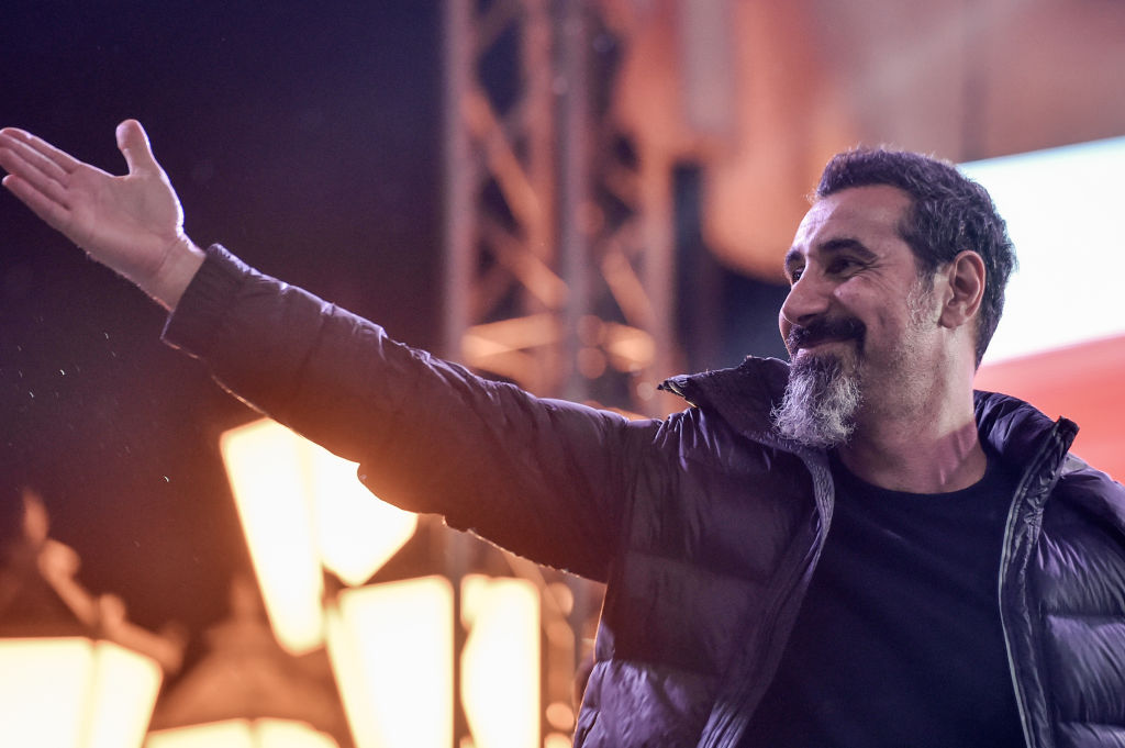 Serj Tankian, the Armenian-American leader of the band System of a Down, gestures to the crowd gathered at Yerevan's Republic Square on May 7, 2018. (Photo by Sergei GAPON / AFP)        (Photo credit should read SERGEI GAPON/AFP via Getty Images)