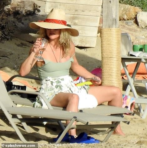 Wine O'Clock!  Kate Hudson parecía estar aprovechando al máximo los climas soleados de Grecia mientras disfrutaba de una copa de vino en una tumbona durante un viaje a la playa el martes.