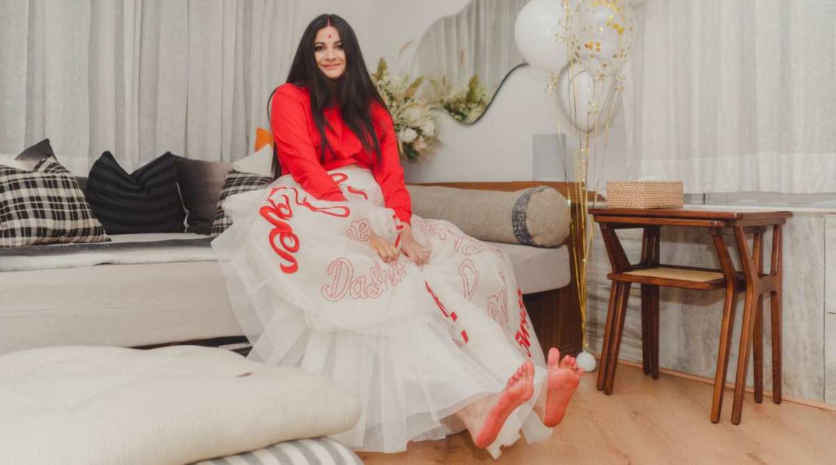 Rhea Kapoor luce el look de novia moderno con una combinación de chaqueta bomber roja y falda de organza