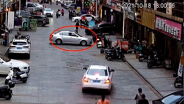 El conductor novato da marcha atrás en la calle, antes de precipitarse accidentalmente hacia la tienda de ropa en Yulin, en la región de Guangxi Zhuang de China.