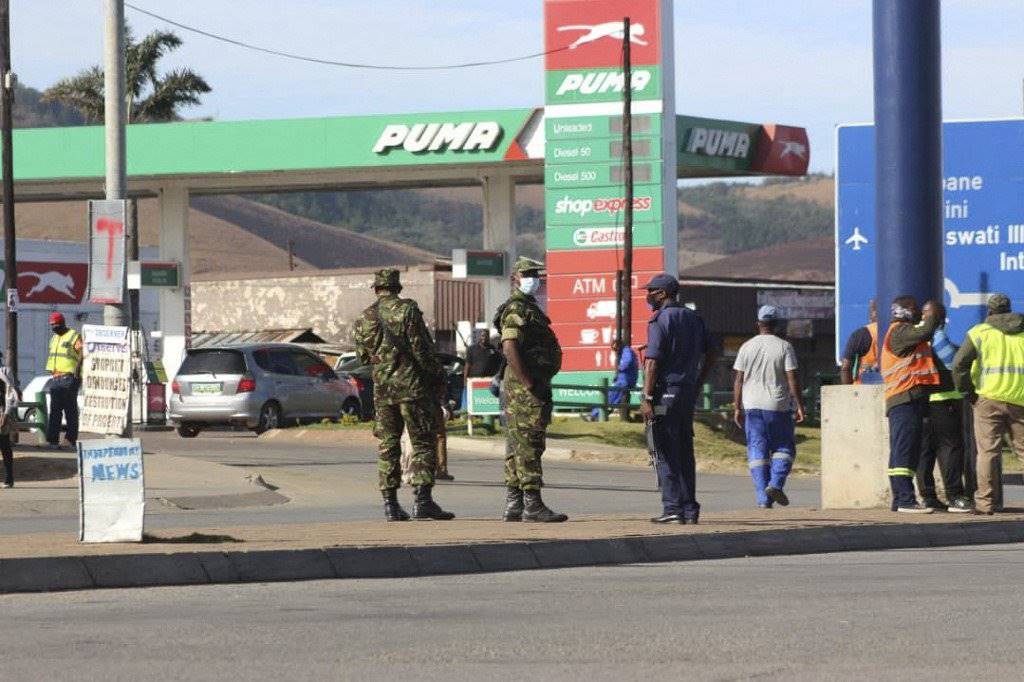 Eswatini soldiers and policemen stand guard in the streets near the Oshoek border post between Eswatini and South Africa. Photo: AFP