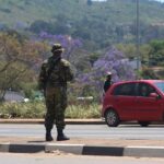 A soldier stands in the road in Manzini on October