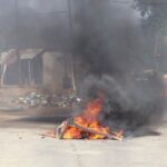 A barricade in the road that is on fire is seen in Mbabane, Eswatini, amid protests.