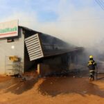 Firefighters extinguish a fire at a supermarket in Manzini, Eswatini on 30 June 2021 in the wake of protests.