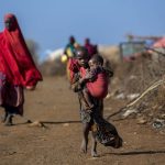 BAY, SOMALIA - MARCH 29: Somalian girl carries her