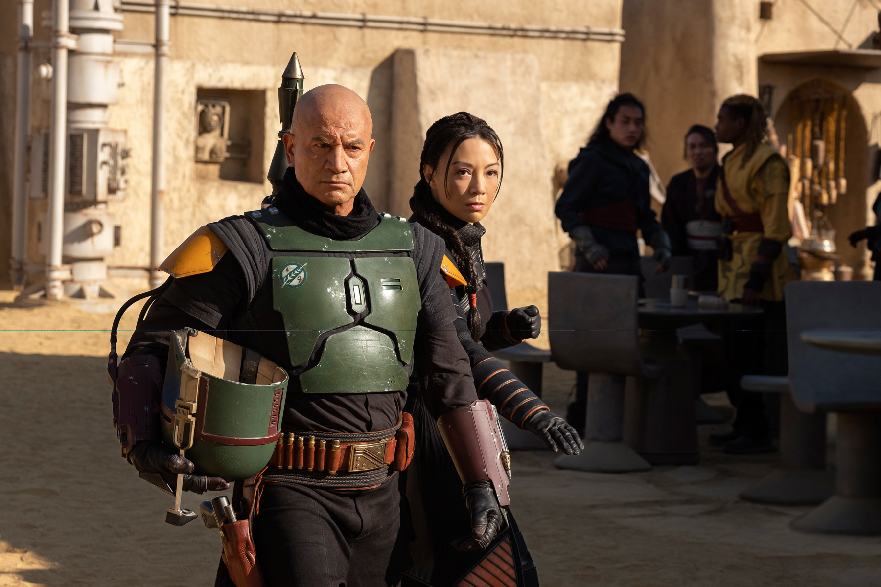 (L-R): Boba Fett (Temuera Morrison) and Fennec Shand (Ming-Na Wen) in Lucasfilm's THE BOOK OF BOBA FETT, exclusively on Disney+. © 2021 Lucasfilm Ltd. & ™. All Rights Reserved.