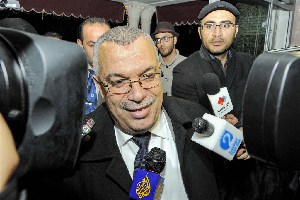 In this file photo taken on February 21, 2013 Tunisian justice minister and candidate for the post of prime minister, Noureddine Bhiri speaks to journalists as he arrives for a meeting at Ennahda ruling party's headquarters in Tunis. Plainclothes officers in Tunisia's capital on December 31, 2021 arrested Noureddine Bhiri, Ennahdha's deputy party president and a former justice minister. The party condemned the arrest as a "dangerous precedent".
FETHI BELAID / AFP