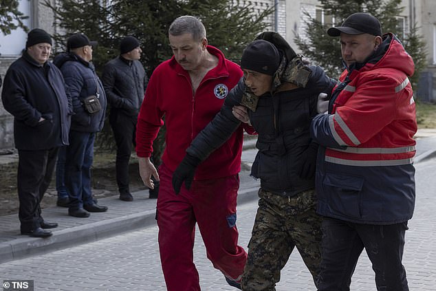 Los voluntarios británicos que viajaron a Ucrania para luchar estaban a solo unos metros de los cuarteles destruidos en un ataque con misiles rusos.  En la foto: un hombre herido en ataques aéreos en el complejo militar cercano de Yavoriv, ​​matando al menos a 35 e hiriendo a decenas, según funcionarios ucranianos.