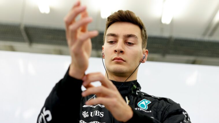George Russell, Mercedes, adjusts his sleeve. Bahrain, March 2022.
