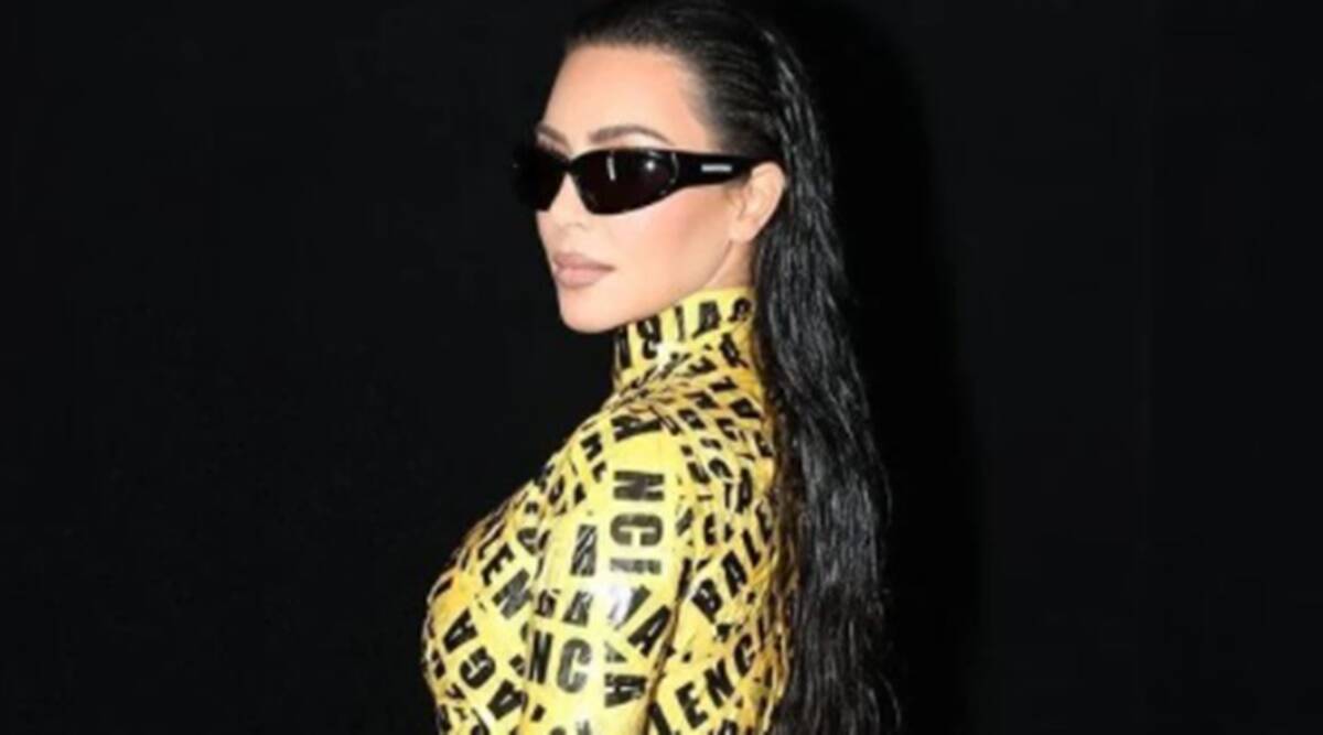 Kim Kardashian, Kim Kardashian news, Kim Kardashian fashion, Kim Kardashian Balenciaga, Kim Kardashian yellow tape dress, Kim Kardashian Paris Fashion Week, indian express news