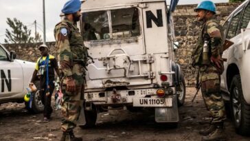 Blue Helmet peacekeepers stand guard next to United Nations vehicles in Goma,  in the Democratic Republic of the Congo.