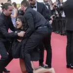 Mujer es retirada de la alfombra roja del Festival de Cine de Cannes tras protestar contra la violencia sexual en Ucrania