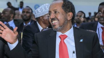 Newly elected Somalia President Hassan Sheikh Mohamud waves after he was sworn-in, in the capital Mogadishu, on May 15, 2022. Somalia handed Hassan Sheikh Mohamud the presidency for a second time following May 15's long-overdue election in the troubled Horn of Africa nation, which is confronting an Islamist insurgency and the threat of famine.