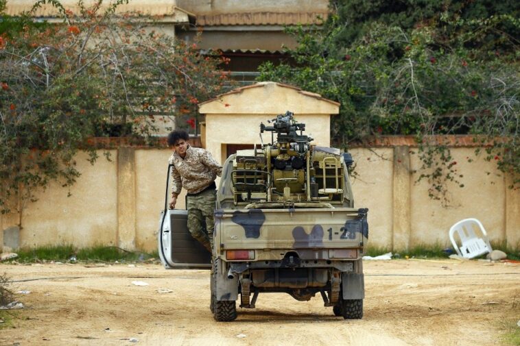 A fighter loyal to the internationally recognised Libyan Government of National Accord (GNA) exits a vehicle in an area south of the Libyan capital Tripoli. (Mahmud Turkia/AFP).