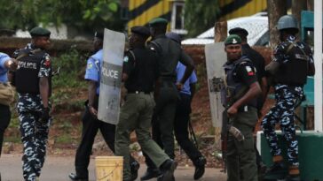 Nigerian police officers patrol in the streets.