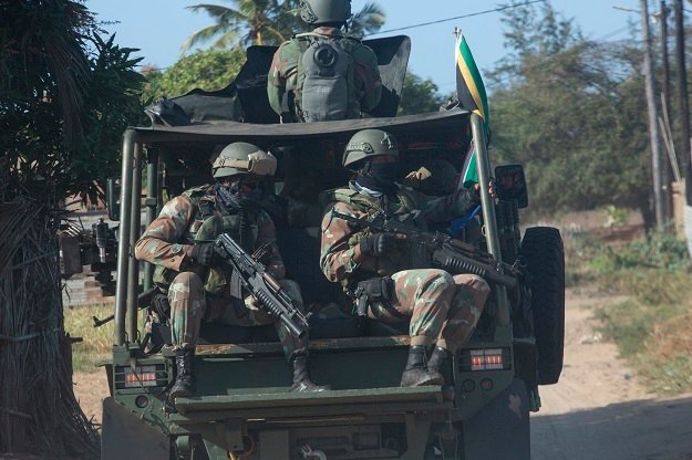 SANDF troops ride along a dirt road in the Maringanha district in Pemba, Mozambique. 