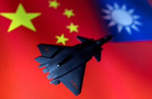 Un modelo del avión de combate chino se ve frente a las banderas china y taiwanesa en esta ilustración tomada el 28 de abril de 2022. Fotografía tomada el 28 de abril de 2022. (Reuters)