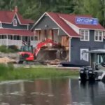 Las imágenes de video muestran a alguien usando imprudentemente una excavadora a través de un lado del edificio Pride Marine Group azul marino, rojo y blanco que se encuentra en Pride of Rosseau Marina, en los lagos Muskoka, en Calgary, Canadá.