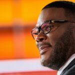 Tyler Perry smiling during a newscast in Don