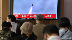 La gente mira una pantalla de televisión que muestra una transmisión de noticias con imágenes de archivo de una prueba de misiles de Corea del Norte, en una estación de tren en Seúl el 4 de octubre de 2022. Corea del Norte disparó un misil balístico de alcance medio el 4 de octubre, que voló sobre Japón, Seúl y Tokio dijo, una escalada significativa a medida que Pyongyang aumenta su bombardeo de prueba de armas sin precedentes.  (AFP)