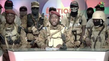 A screen grab shows from state TV, army Capt. Kiswendsida Farouk Azaria Sorgho reads a statement in Ougadougou, Burkina Faso. (Photo by Radio Television du Burkina (RTB)/Anadolu Agency via Getty Images)