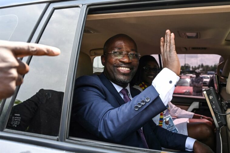 Charle Ble Goude, former right-hand man to ex-president Laurent Gbagbo waves from his car upon his arrival at Felix-Houphouet Boigny airport in Abidjan.