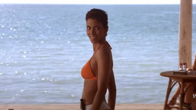 Halle Berry looks over her shoulder in an orange bikini in Die Another Day.