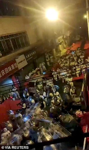 Los manifestantes se han enfrentado con la policía antidisturbios que vestían trajes blancos para materiales peligrosos en China, y los manifestantes arrojaron botellas de vidrio a los funcionarios en escenas caóticas y violentas.