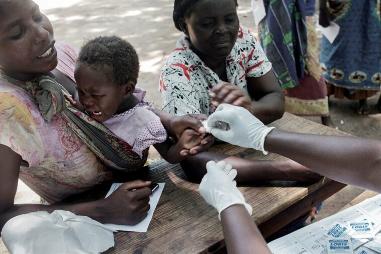 Malawians going through a medical checkup by a paramedic from a non-governmental organisation in Makhanga in the southern Malawian district of Nsanje.