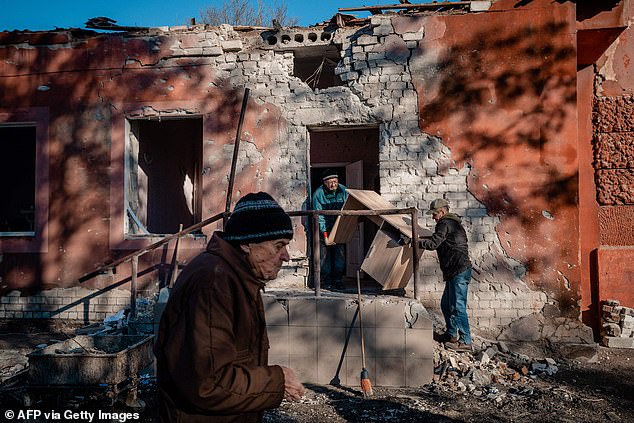 Los trabajadores transportan muebles de la unidad de maternidad del hospital dañados después de un bombardeo ruso en Kherson