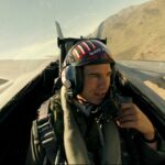 Tom Cruise talking into the radio in an airplane during Top Gun: Maverick.