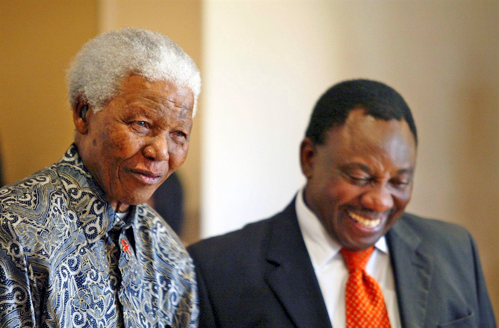  Former South African president, Nelson Mandela, and Cyril Ramaphosa, sharing a humorous moment. 