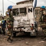 Blue Helmet peacekeepers stand guard next to United Nations vehicles in Goma,  in the Democratic Republic of the Congo.
