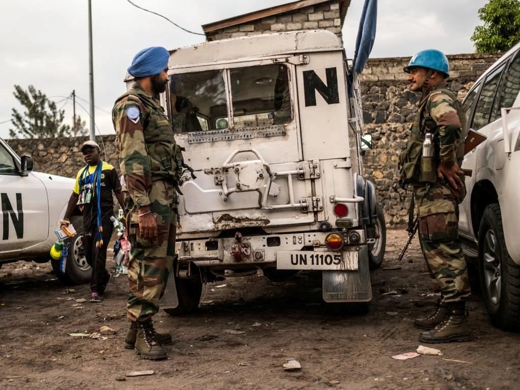 Blue Helmet peacekeepers stand guard next to United Nations vehicles in Goma,  in the Democratic Republic of the Congo.