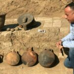 Mostafa Waziri, the head of Egypt's Supreme Council of Antiquities, sitting next to artefacts discovered at an excavation of an 1,800-year-old "complete residential city from the Roman-era."