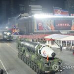 N.K. leader calls for stronger military power in photo session with parade participants