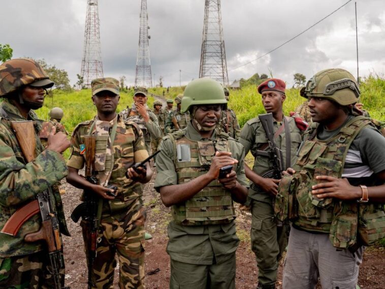 M23 rebels talk before leaving their position in Kibumba in eastern Democratic Republic of Congo.
