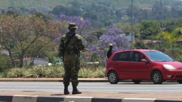 A soldier stands in the road in Manzini during unrest in Eswatini.