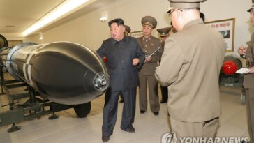 (LEAD) N. Korean leader urges more production of weapons-grade nuclear materials; photos of tactical nuclear warheads released