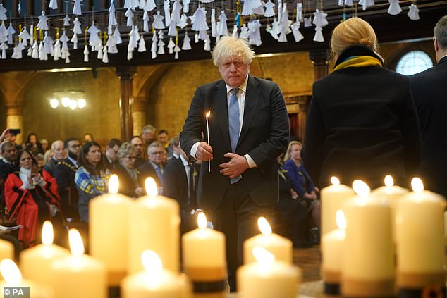 El ex primer ministro Boris Johnson enciende una de las 52 velas, una por cada semana de la guerra.