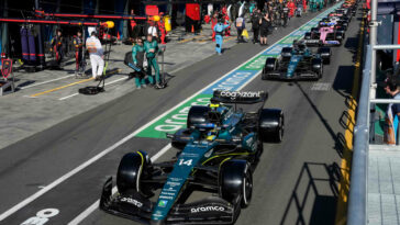 Aston Martin's Spanish driver Fernando Alonso and other drivers line up in the pit lane during a