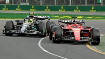 Ferrari's Monegasque driver Charles Leclerc (R) and Mercedes' British driver Lewis Hamilton drive