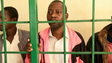 Self-proclaimed pastor Paul Nthenge Mackenzie, (C) who set up the Good News International Church in 2003 and is accused of inciting cult followers to starve to death "to meet Jesus", appears at the Shanzu law courts in Mombasa on 5 May 2023.
