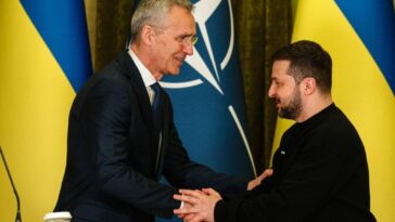 NATO Secretary General Jens Stoltenberg (L) shakes hands with President Volodymyr Zelensky in Kyiv on April 20, 2023