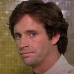Robert Hays stands with a disappointed expression in Airplane!
