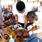 Health officials examine children with malnutrition in a clinic set up in collaboration with MSF in Katsina State, northwest Nigeria, in July 2022. MSF has recorded a sharp rise in malnutrition in the region. (PIUS UTOMI EKPEI / AFP)