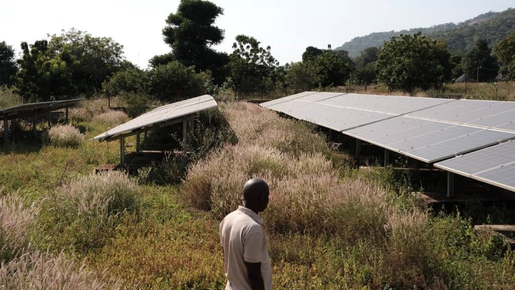 A man walks past a large set of solar panels that provide over 600 people with electricity in Ibel, Senegal. Solar panels in various shapes and sizes offer cheap, consistent electricity to many communities with little or no access to mains power where the sun shines most days of the year. (Guy Peterson/AFP)