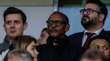 Rwanda's President Paul Kagame (C) attends the UEFA Champions League quarter final first-leg football match between Arsenal and Bayern Munich at the Arsenal Stadium, in north London, on April 9, 2024.