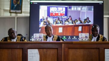 Uganda's deputy chief justice and head of the court Richard Buteera (C) delivers judgment on consolidated petitions challenging the constitutionality of the Anti-Homosexuality Act, in Kampala on 3 April 2024. (Badru KATUMBA / AFP)